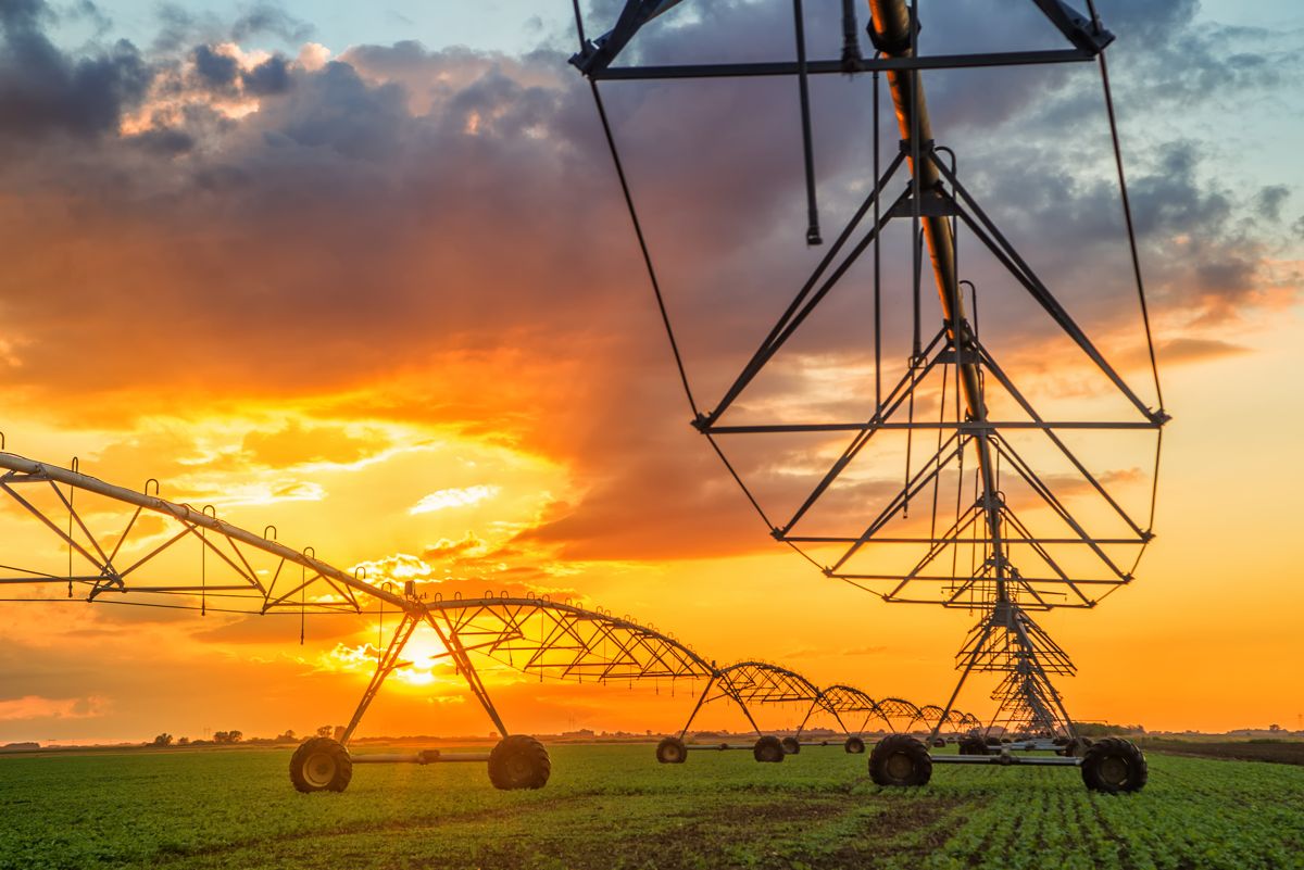 Center-pivot irrigation machine at sunset
